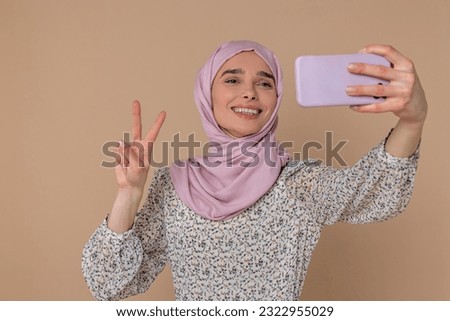 Happy young woman making selfie and smiling