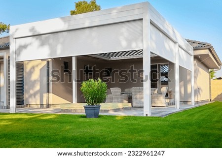 Modern BAT R Bioclimatic Aluminum Pergolas. Experience luxury outdoors with BAT R Bioclimatic Pergolas. Stylish, durable, and customizable – perfect for premium gardens and terraces. Royalty-Free Stock Photo #2322961247