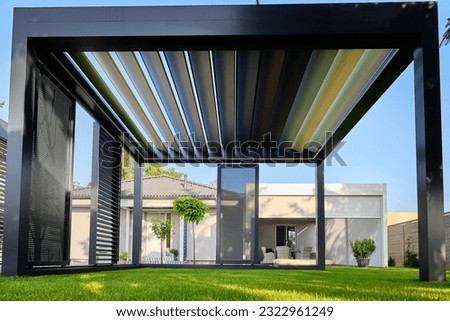 Modern BAT R Bioclimatic Aluminum Pergolas. Experience luxury outdoors with BAT R Bioclimatic Pergolas. Stylish, durable, and customizable – perfect for premium gardens and terraces. Royalty-Free Stock Photo #2322961249