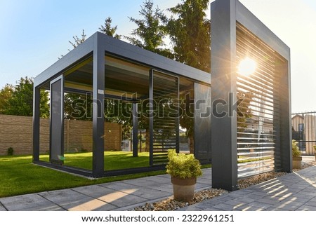 Modern BAT R Bioclimatic Aluminum Pergolas. Experience luxury outdoors with BAT R Bioclimatic Pergolas. Stylish, durable, and customizable – perfect for premium gardens and terraces. Royalty-Free Stock Photo #2322961251