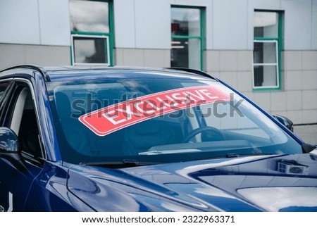 inscription exclusive on purple car windshield, car dealers and manufacturers, global automobile manufactures, special offer for buyers from car dealership