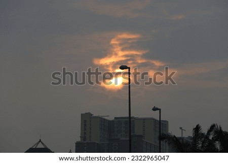 urban sunset with view of buildings, service street and street lights