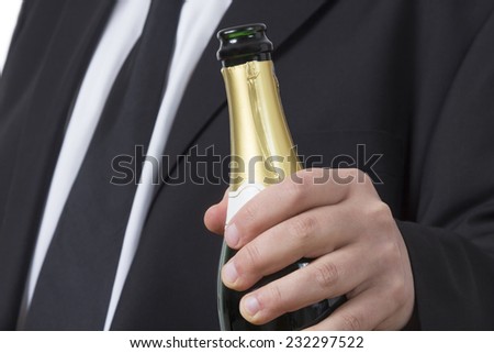 Man in a suit with a open bottle of Champagne 