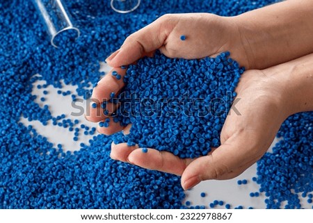 White plastic grain, plastic polymer granules,hand hold Polymer pellets, Raw materials for making water pipes, Plastics from petrochemicals and compound extrusion, resin from plant polyethylene. Royalty-Free Stock Photo #2322978867