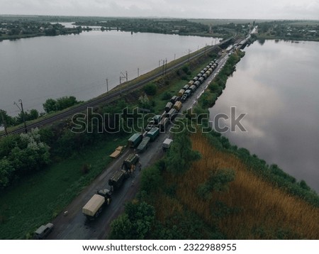 Pontoon bridge of the Ukrainian army. Installation of a temporary crossing near the destroyed bridge. Soldiers collect pontoon ferry. Top view from a drone. Nikopol, UKRAINE – May 26, 2020 Royalty-Free Stock Photo #2322988955