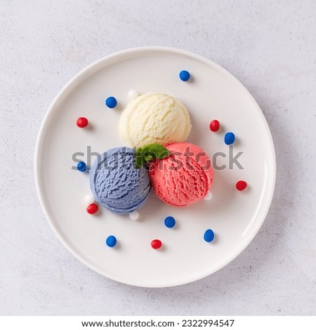 Patriotic colors ice cream scoops on white plate, Red, white and blue ice cream closeup, top view, copy space, square format