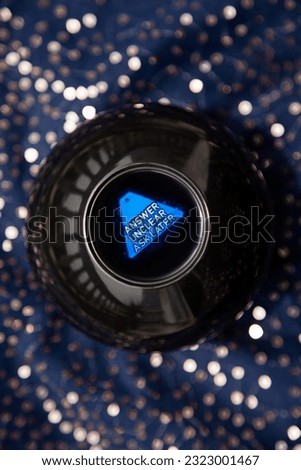 Magic ball game for predicting the future says Answer Unclear to a question. Fortune telling toy saying the future is unknown Royalty-Free Stock Photo #2323001467