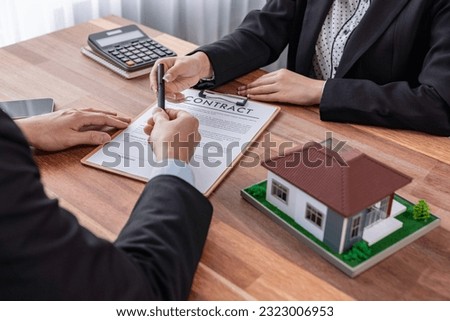 Buyer sign house loan contract with satisfaction after agree to term and condition of house loan with real estate agent. Contract document with client's signature as housing business concept. Jubilant