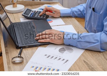Man at work at desk, accountant Royalty-Free Stock Photo #2323016231