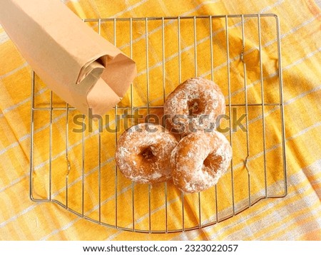 stack of donuts with icing powdered sugar