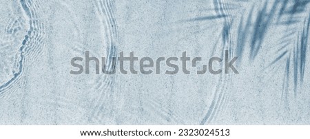 palm leaf shadow on abstract white sand beach background with sunlight in transparent water wave from above, beautiful nature scene summer vacation concept with copy space 