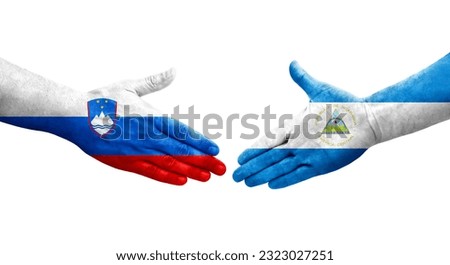 Handshake between Nicaragua and Slovenia flags painted on hands, isolated transparent image.