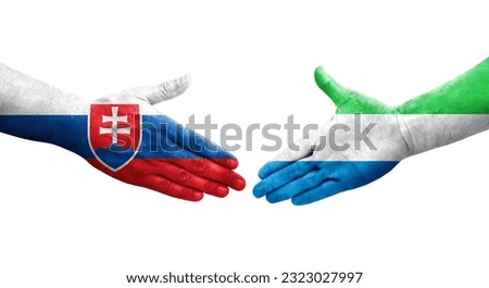 Handshake between Sierra Leone and Slovakia flags painted on hands, isolated transparent image.