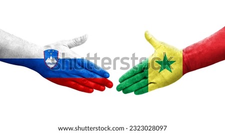 Handshake between Senegal and Slovenia flags painted on hands, isolated transparent image.