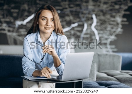 Young business woman working on laptop in chill office zone