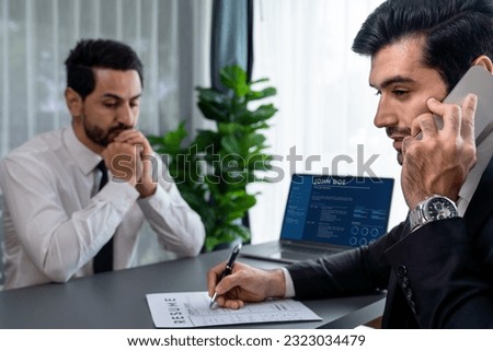 Candidate feeling dissatisfied and lose confidence during job interview as interviewer talk on the phone, ignoring and showing disinterest. Negative interview experience for applicant. Fervent Royalty-Free Stock Photo #2323034479