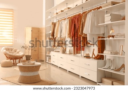 Stylish clothes with shoes and accessories in boutique Royalty-Free Stock Photo #2323047973