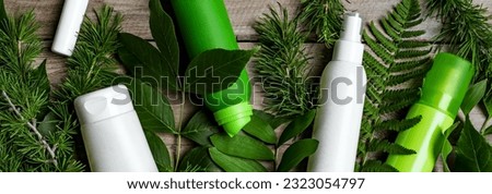 Mosquito repellents and sprays anti stinging insects on wooden background and leaves of green forest plants, banner. Eco organic insect repellent for people and pets concept. Royalty-Free Stock Photo #2323054797
