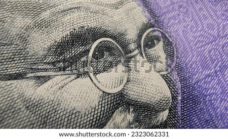 Indian rupee currency note or reserve bank of India paper money extreme macro detail close up of Mahatma Gandhi eyes. Inflation, banking, savings, investment, tax, wealth and cash concept. Royalty-Free Stock Photo #2323062331