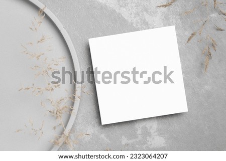 Square paper botanical card mockup with copy space on grey stony background
