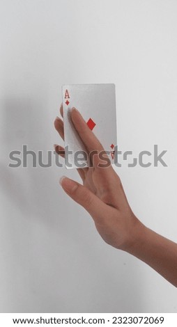 Hand playing blue deck card