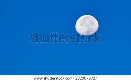 Isolated picture of moon at morning blue sky above Lovine beach, West Bali, Indonesia 