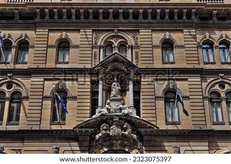 North facade of heritage-listed landmark building in Victorian Italian Renaissance style featuring a white marble statuary group of Queen Victoria flanked by allegorical figures. Sydney-NSW-Australia. Royalty-Free Stock Photo #2323075397
