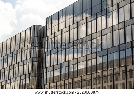 Tinted glass facade. Rounded corner glasses, elements of modern architecture.