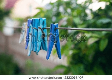 Multi-colored clothespins on a clothesline close up.
