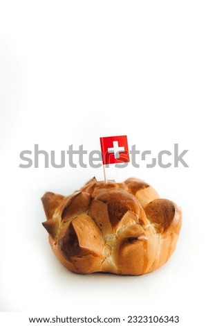 Swiss national holiday celebrated annually on August 1st with traditional bread called in German Augustweggen. Isolated on white, copy space.
