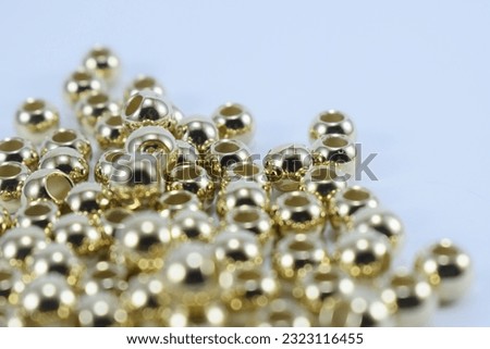 gold color beads, with some parts in focus and other parts blur