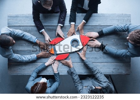 Top view of a business team members launching rocket startup new business success symbol concept