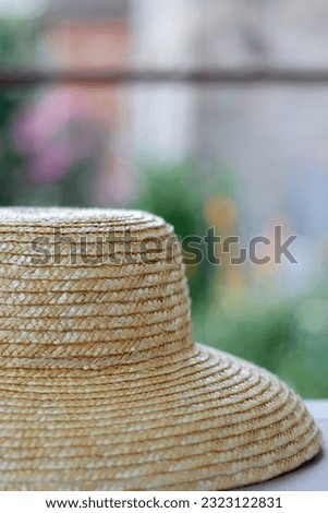 Straw hat hanging in the garden. Selective focus.
