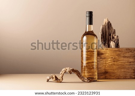 Bottle of white wine with a composition of old wood. Neutral beige background for product branding, identity, and packaging. Minimalistic compisition. Copy space, front view.
