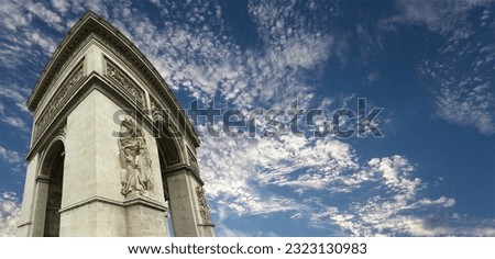 Arc de Triomphe (against the background of sky with clouds), Paris, France. The walls of the arch are engraved with the names of 128 battles and names of 660 French military leaders (in French) 