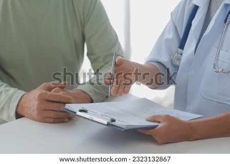 Doctor giving hope. Close up shot of young female physician leaning forward to smiling elderly lady patient holding her hand in palms. Woman caretaker in white coat supporting encouraging old person Royalty-Free Stock Photo #2323132867