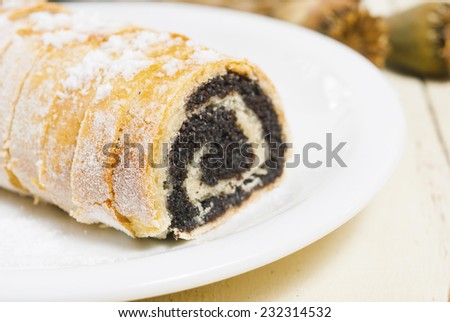 granulated sugar topped poppy seed rolls on rusty wood table