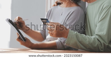 Shocked aged couple become victims of online fraud using credit card phone to pay for goods order service online on suspicious website. Frustrated older spouses overspending money at internet shopping Royalty-Free Stock Photo #2323150087