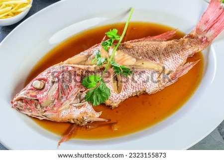 Flavors of the Sea: Top Close-Up of Whole Red Snapper Fish Cooked in Ginger Soy Sauce on Plate in 4K