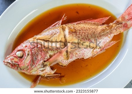Flavors of the Sea: Top Close-Up of Whole Red Snapper Fish Cooked in Ginger Soy Sauce on Plate in 4K