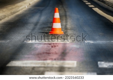 Warning cones on the road during traffic in the city.