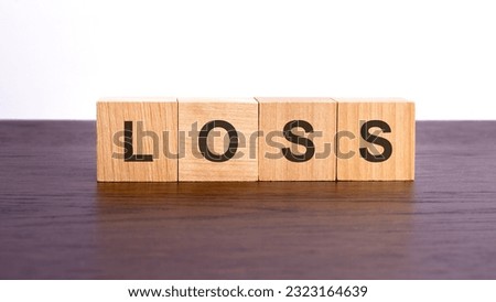 loss written in wooden cubes. conceptual word collected of wooden elements with the letters. stock image, brown background.