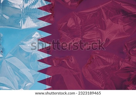 Qatar flag is shown on the plastic bottles. Ecology concept with environmental pollution from household and industrial waste. Concept of stopping plastic pollution. Ban disposable products.