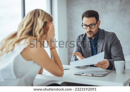 Mad male worker yelling at female colleague asking her to leave office, multiracial coworkers disputing during business negotiations, employees cannot reach agreement, blaming for mistake or crisis Royalty-Free Stock Photo #2323192091