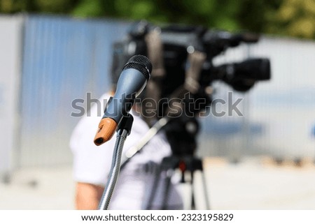 A microphone on a stand prepared for a television interview.