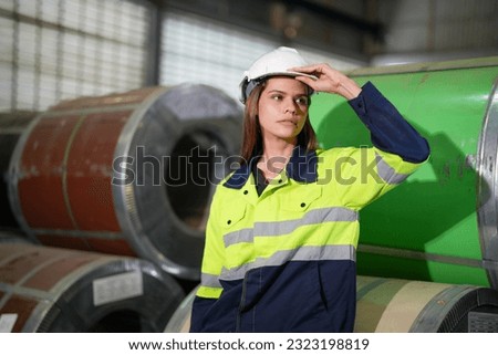 factory woman worker sitting on steel roll and suffering stress fail at factory workshop equipment.
