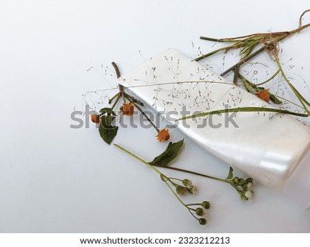 Natural organic cosmetic skincare packaging mock up white with flowers and green leaves on white background.  bio science beauty concept .  Mockups.  white cosmetic tubes. close-up