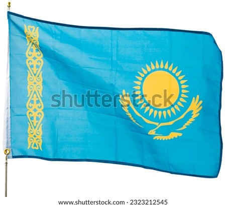 National blue flag of Kazakhstan with golden sun above soaring eagle in center representing future of country, freedom and cultural heritage of Kazakh people fluttering on flagpole. Isolated over