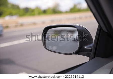 Car mirror reflects introspection, navigation, and perspective. Symbolizes self-awareness, road ahead, and the journey within. Conceptual image