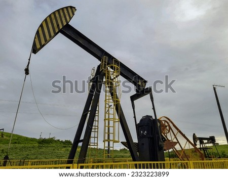 Equipment pumping oil in a production field
